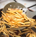 Cooking potato fries in oil Royalty Free Stock Photo