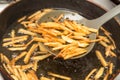 Cooking potato fries in oil Royalty Free Stock Photo