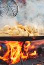 Cooking potatoes with eggs on an open fire Royalty Free Stock Photo