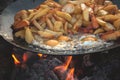 Cooking potatoes with eggs on an open fire
