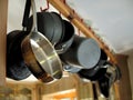 Cooking pots and pans hanging in kitchen. Royalty Free Stock Photo