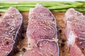 A cooking preparation of raw slices of fish with ingredients