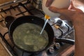 Cooking process of frying huge ostrich egg on frying pan Royalty Free Stock Photo