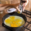 Cooking process of frying huge ostrich egg on frying pan Royalty Free Stock Photo
