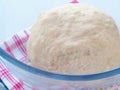 Cooking process. Preparing dough for cakes, pastries, buns or pizza. Leavened dough in transparent bowl.