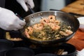 cooking process of Suquet de Peix soup with potatoes, herbs and fish with the addition of picada close-up in a saucepan Royalty Free Stock Photo