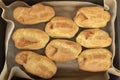 Cooking profiteroles, puffs, popovers, eclair. Fresh baked goods on baking sheet top view Royalty Free Stock Photo