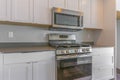 Cooking range and wall mounted microwave inside a modern kitchen Royalty Free Stock Photo