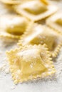 Cooking ravioli on a floured kitchen table