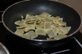 Cooking Ravioli Italian Pasta inside Black Pan with Butter