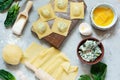 Cooking Raviolli homemade pasta with ricotta and spinach on a blue background, traditional Italian cuisine Royalty Free Stock Photo