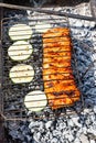 Cooking raw pork ribs with sliced squash in grill Royalty Free Stock Photo