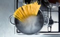 Cooking raw spaghetti in the boiling water contained in a saucepan Royalty Free Stock Photo