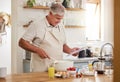 Cooking, recipe and senior man with a video online for breakfast in the kitchen of his house. Elderly man reading