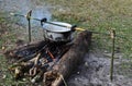 Cooking rice using pot in outdoor nature. Food Camping cooking over a fire using dry firewood and use stone as stove stand. Royalty Free Stock Photo