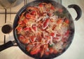 Cooking river crayfish, or crawfish, at home on a traditional recipe. A lot of red, freshwater lobsters boiling in a big bowl on Royalty Free Stock Photo