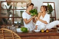 Cooking. Romantic Man Giving Bundle Of Herbs To Woman. Couple Preparing Healthy Food At Kitchen In Tropical Villa.