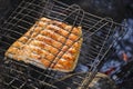 Cooking salmon over camp fire