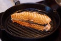 Cooking salmon steak fish on the grill pan