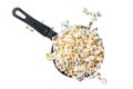 Cooking salted popcorn in a skillet. Isolated, white background. Royalty Free Stock Photo