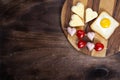 Cooking, sandwiches, heart-shaped snacks, top view. Heart-shaped sausages and sandwiches with cherry tomatoes with Royalty Free Stock Photo