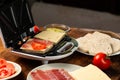 Cooking sandwiches in a sandwich maker. Different ingredients - bread, cheese, vegetables on a wooden background Royalty Free Stock Photo