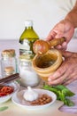 Cooking sauce using mortar and pestle Royalty Free Stock Photo