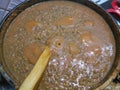 Wooden spoon stirring lentil soup