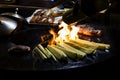 Cooking sausages and grilled vegetables over a campfire. Recreation and summer camping in the countryside. Night