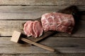 Cooking schnitzel. Raw pork meat and tenderizer on wooden table, top view Royalty Free Stock Photo