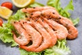 Cooking seafood shrimps prawns served on a table background - fresh shrimp on lettuce salad vegetable with ingredients herb Royalty Free Stock Photo