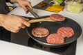 Cooking several beef burgers on an electric griddle