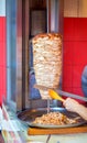 Cooking shawarma in a street food tent. Roasting meat on a spit for fast food