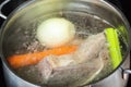 Boiling beef broth in stew pan close up Royalty Free Stock Photo