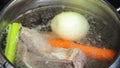 Boiling beef stock in stew pan close up close up Royalty Free Stock Photo