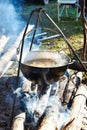 Cooking soup in hiking bowler over campfire Royalty Free Stock Photo