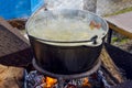 Cooking soup on the nature in a cauldron