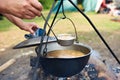 Cooking soup over campfire in hike Royalty Free Stock Photo