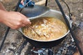 Cooking soup over campfire in hike Royalty Free Stock Photo