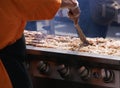 Cooking spicy kebabs at street fair,