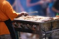 Cooking spicy kebabs at street fair