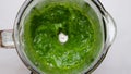 Cooking spinach smoothie in blender. Green vegetable leaves blended in blender. Slow motion. Healthy detox drink concept