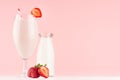 Cooking of spring fresh pink milkshake with strawberry, bootle of milk on soft pink background, copy space.