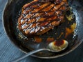 Cooking steak with butter basting motion blur