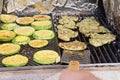 Cooking steaks and zucchini medallions are cooked on gas-grill grate Royalty Free Stock Photo