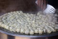 Cooking steamed traditional Nepalese momos in the street kitche