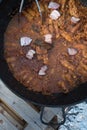 Cooking stew campfire concept, stew preparing open grill steaming Royalty Free Stock Photo