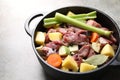 Cooking stew. Uncooked meat and vegetables in pot on light grey table, closeup Royalty Free Stock Photo