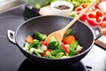 Cooking stir fried vegetables in a wok