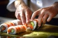 Cooking sushi rolls. Cook& x27;s hands close-up in transparent gloves. Crafting Rolls from rice, cucumber, salmon